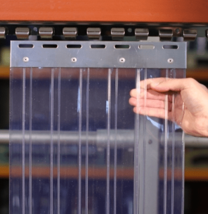 Workers installing PVC strip curtains for industrial use